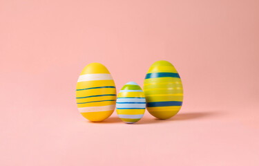 Minimal Easter layout with colorful eggs on a pink background. Easter family eggs . creative concepts. Easter card with copy space for text.