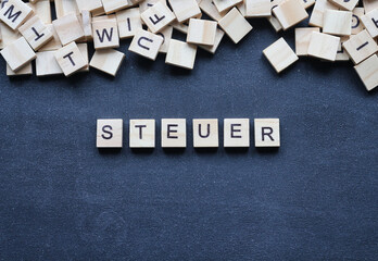Holzbuchstaben auf Tafel, Steuer