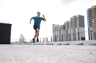Fototapeta na wymiar Fitness, workout, sport, lifestyle concept. Middle-aged man running in the city