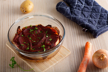 Layered moussaka with tomato sauce and herbs