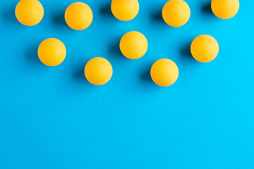 Orange table tennis or ping pong balls on blue background