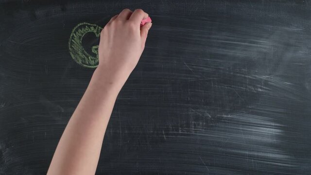 Colorful chalks are written the words girl power on a chalkboard, timelapse. Concept of feminism.