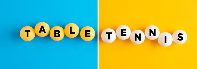 The word table tennis written on table tennis balls on blue and yellow colorful background.