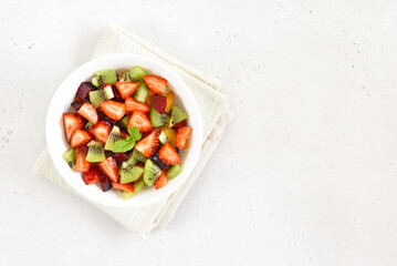 Healthy food fruit salad from kiwi and strawberry in bowl