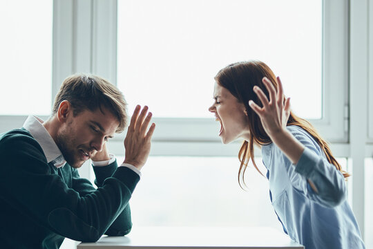 emotional man and woman sitting at the table conflict quarrel communication