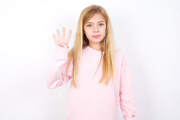 beautiful caucasian little girl wearing pink hoodie over white background showing and pointing up with fingers number four while smiling confident and happy.