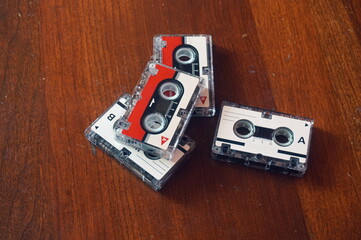 Four Mini Cassette Tapes Against Maple Wood Background