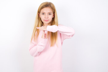 beautiful caucasian little girl wearing pink hoodie over white background feels tired and bored, making a timeout gesture, needs to stop because of work stress, time concept.