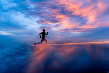 Fototapeta na wymiar Male runner silhouette on fiery sunset backdrop