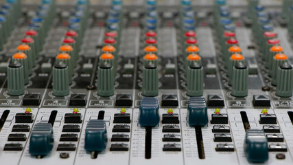 Fototapeta premium Sound mixer with continuous colored adjustment buttons and loudspeaker adjustments