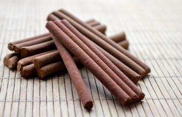 Nepalese sandal tree incense aroma sticks on a bamboo surface