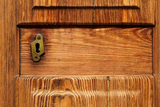 closeup of golden keyhole in elegance wooden door