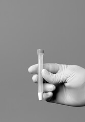 nurse hand with vial, swab inside, black and white, gray background