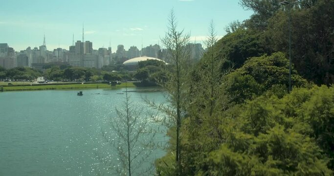 Aerial rising shot of Ibirapuera park with unrecognizable people exercising