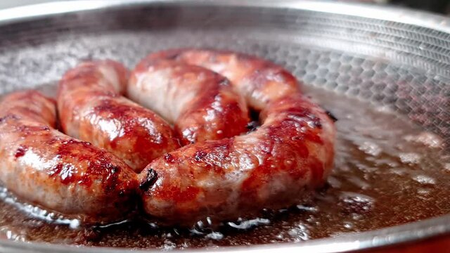 sausage to fry in a pan. movement from left to right