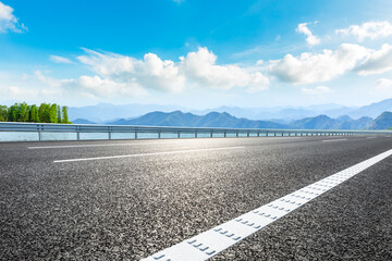 Asphalt highway and lake landscape on a sunny day.