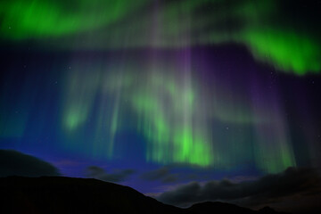 The dancing northern lights of the Aurora Borealis above Landmannalaugar, Fjallabak Nature Reserve, Iceland
