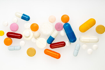 Set of different colorful pills and capsules isolated on white background.