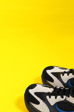 Women's sneakers are in isolation on a yellow background with a place for inscription. High quality photo
