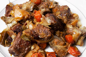close-up of a pre-cooked beef Ragout with vegetables dish on a plate
