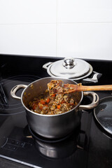 Cooking veal ragout with vegetables in a home kitchen. Homemade food concept.