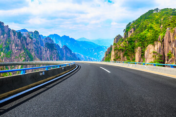 Asphalt road and green mountain natural landscape.