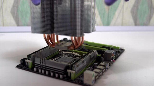 The repairman installs the main processor heatsink. Home PC Maintenance and Upgrades