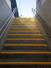Yellow steps at train station, stairs to railway station at Sitges, Spain