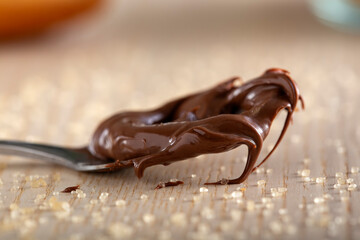 Teaspoon with chocolate spread and brown sugar