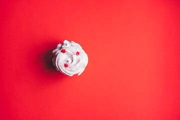 Fresh marshmallows on a red background. Zephyr, meringue. The concept of home-cooked food, sweets....