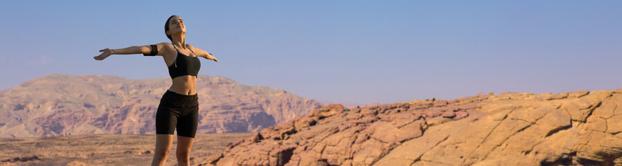 A thin athletic girl takes a break between classes on the background of mountains in the early morning