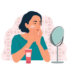 A girl in front of a table mirror, applies cream. Female enjoying skin care use organic cosmetics isolated on white. Natural cleansing product.Daily beaty routine and skin care at home.