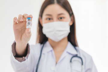 Covid-19, coronavirus hand of asian young woman or female doctor, nurse holding vaccine vial, healthcare and medical. Vaccination, immunization or disease prevention against or virus pandemic concept.