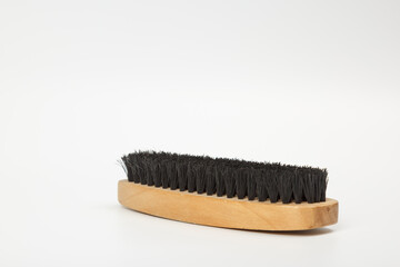 Brush for clothes and shoes made of wood. Clothes brush isolated on white background. Horsehair brush. Wooden clothes brush.