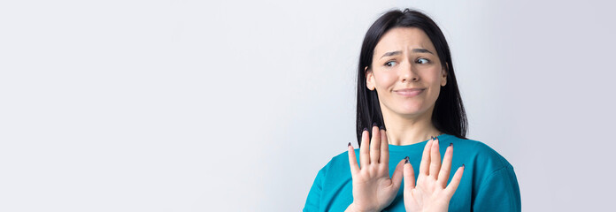 Portrait of uncomfortable pretty brunette, raising palms in stop gesture. That is enough, thanks.