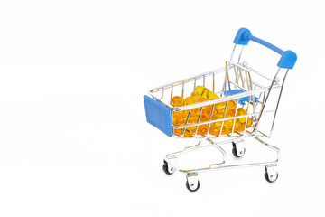 A grocery cart filled with yellow capsules of omega-3 fatty acids on a white background. Healthy shopping and lifestyle concept.