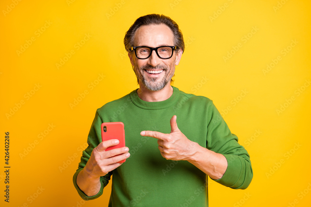 Sticker photo of handsome man hold phone indicate forefinger wear eyewear green pullover isolated yellow col