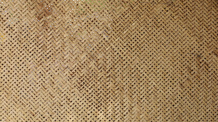 Fototapeta na wymiar Weave pattern background and bamboo texture. The ancient classic pattern of bamboo wickerwork is part of traditional Thai appliances for the background and wallpaper. Selective focus