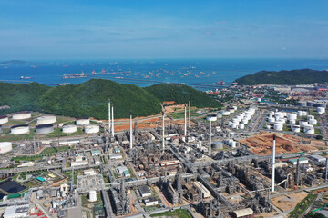 Aerial view of industrial estate and petrochemical oil refinery daytime. Oil and gas tanks with...