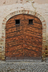 The front door of a medieval house in Montecosaro, an old town in the Marche region of Italy.