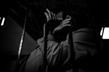 Portrait of women desperate to catch the iron prison,prisoner concept,thailand people,Hope to be...
