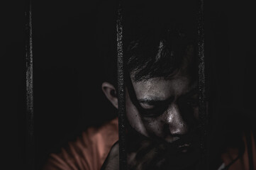 Asian man desperate at the iron prison,prisoner concept,thailand people,Hope to be free,Serious...