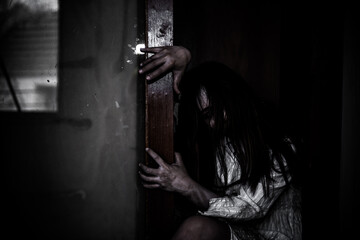 Portrait of asian woman make up ghost face with blood,Horror scene,Scary background,Halloween...