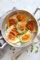 Homemade fried ravioli. Fried polish potato pierogis. Top view with copy space. Vegetarian and vegan food.