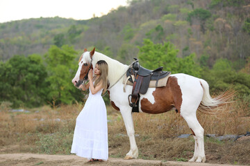 Women on skirt dress Riding Horses On field landscape Against Sky During Sunset