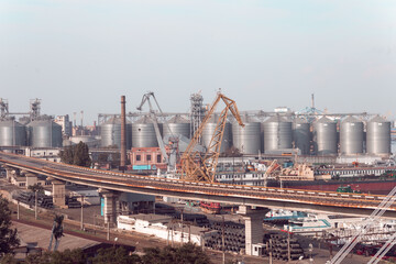 Container import and export logistics, cargo harbor view. Panorama of harbor cranes. Yellow loading crane. Black Sea commercial port, container loading by crane. Shipping.