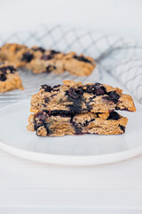 Homemade oatmeal scones with berries on white plate. Vegan sweet baked food. Gluten free pastry.