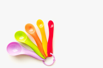 colored measuring spoons on white background, measuring spoons on white background