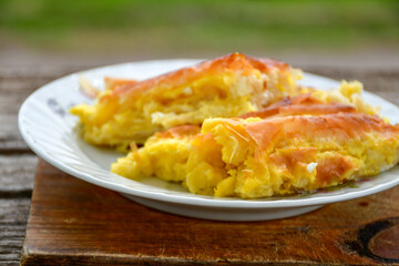 Fototapeta na wymiar Bakery .Home made cheese pie with phyllo pastry and organic eggs. Bulgarian banitsa