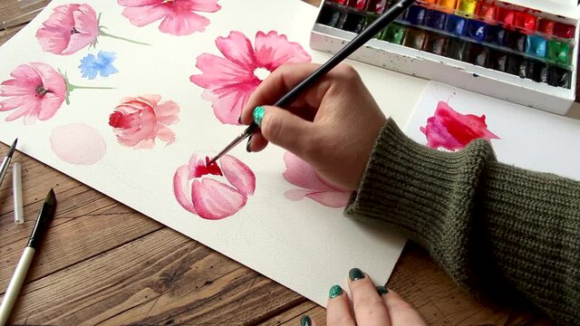 Painting pink flower with watercolors close up